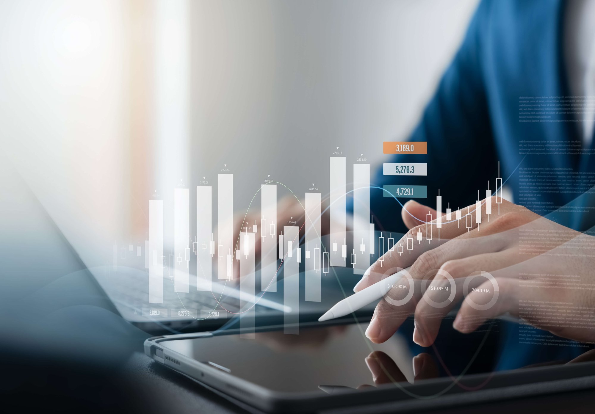 Geschäftsmann nutzt Laptop und Tablet, um Marktdaten und Absatzprognosen zu analysieren