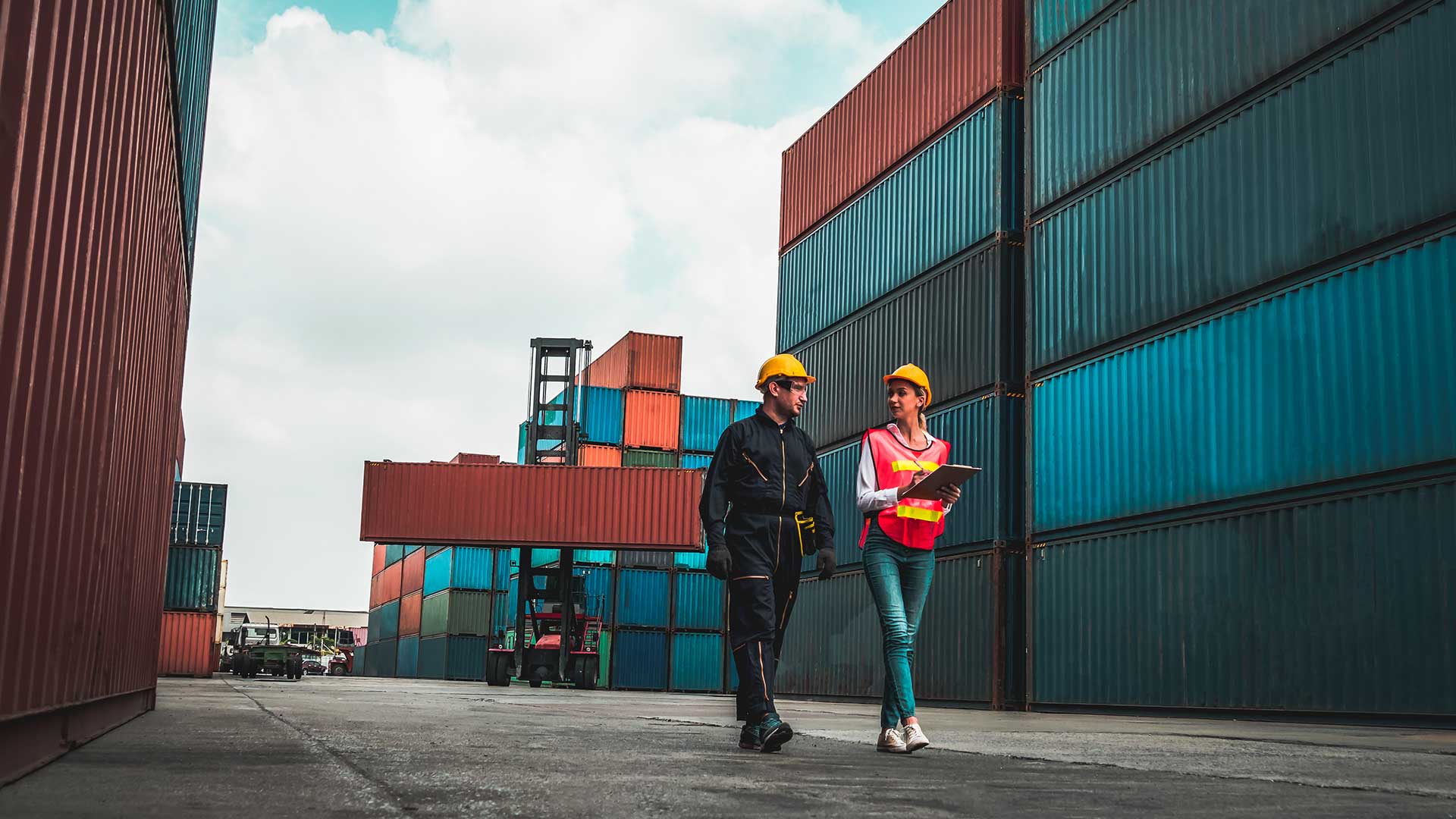 Two coworkers in a yard with container