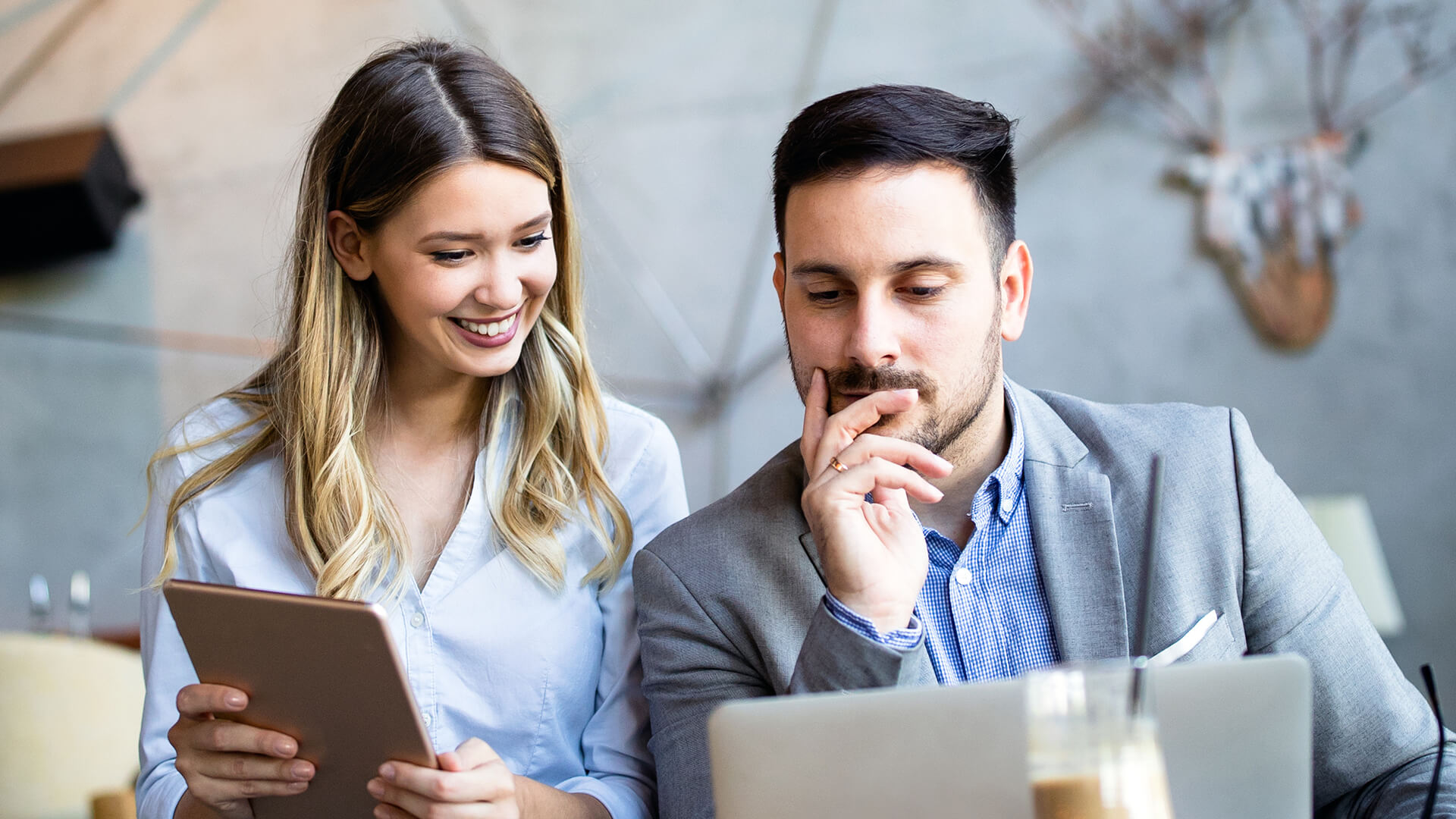 Woman and man working together on a laptop